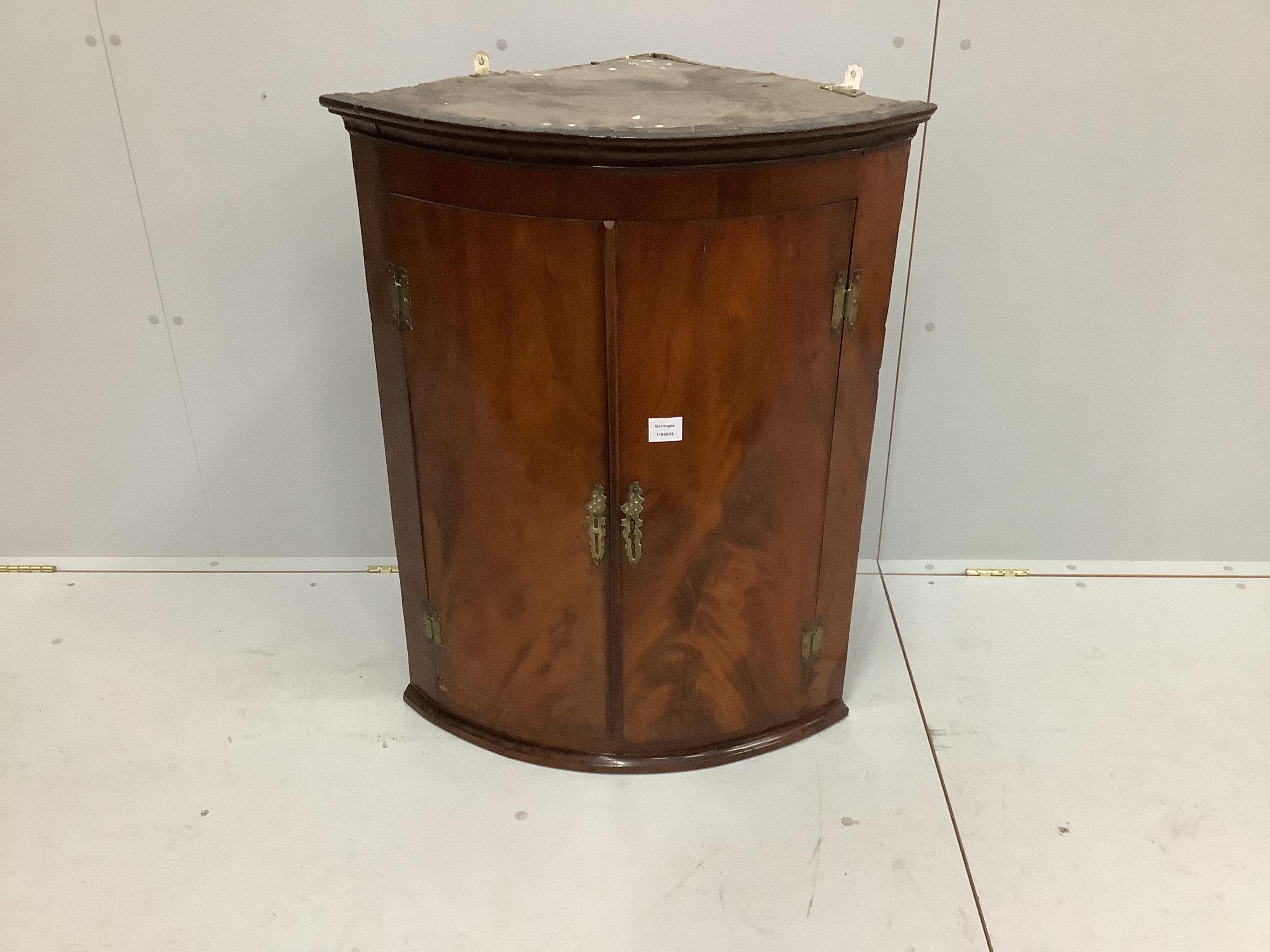 A George III mahogany bow front hanging corner cupboard, width 69cm, depth 48cm, height 90cm